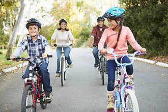 Hispanic Family On Cycle Ride In Countryside