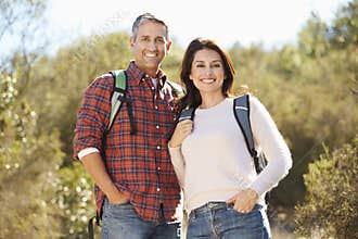 Portrait Of Couple Hiking In Countryside