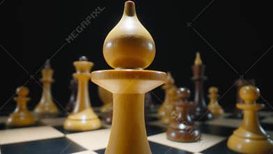 Macro dolly shot of a white bishop chess piece on a chessboard