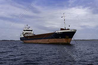 The general cargo ship \"Fri Brevik\" anchored just outside Penzance harbour in Cornwall