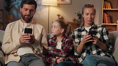 Caucasian family parents mother father using mobile phone smartphones scrolling gadgets addict dependence internet