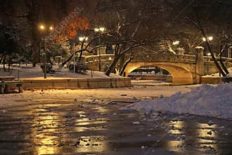 Winter night landscape with frozen lake in Cismigiu Park - Bucharest, Romania