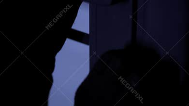 burglar, man in gloves with picklocks trying to open a door lock, close-up