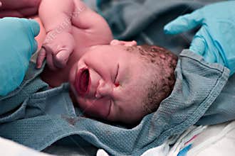 Newborn baby being cleaned up