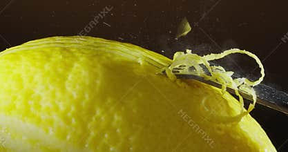 A closeup image showcasing the extraction of vibrant lemon zest from fresh lemons