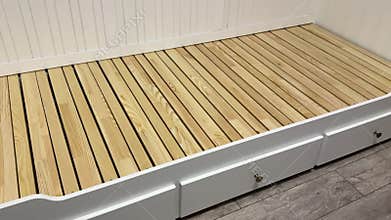 Assembling an ottoman. Installation of base, backrest, and handrails. Installed pull-out linen drawers