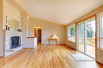 Empty living room with a fireplace and glass sliding door