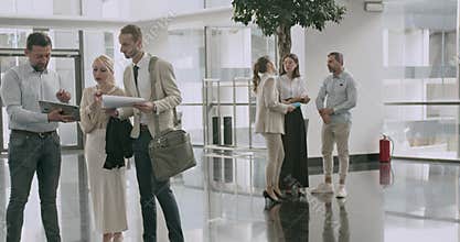 Business Professionals Collaborate in a Modern Open Office, Discussing Work, Strategies, and Teamwork