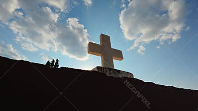 Marble Cross on Greek Orthodox Church with Sunlight Appearing Behind Symbol
