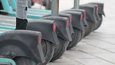Electric scooters lined up on city street at night