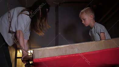 Children play in a large maze, roll a ball, completing a task in the quest room.