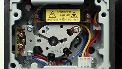 Detailed View Inside Smart Meter Calibration Unit with Silver Rotor and Multicolored Wiring A High Angle Close Up Shot Featuring