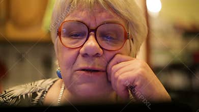 Modern elderly woman using skype