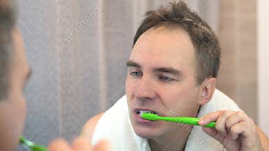 Mirror, bathroom and man brushing teeth, morning and grooming routine with fresh breath. Person, reflection and guy with