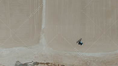 Drone video a tractor is spreading cassava on a cassava drying field