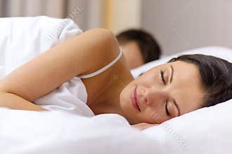 Happy couple sleeping in bed