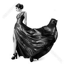 Fashion woman in fluttering dress. BW image. Isolated