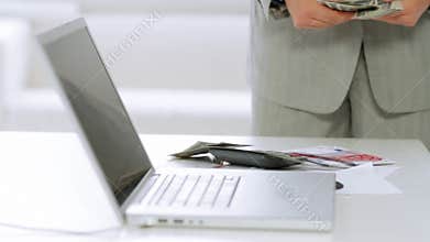 Frustrated businessman throwing dollar banknotes