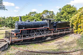 A retired old steam locomotive on a turntable for turning trains around.