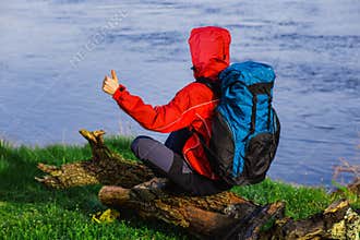 backpacker, resting near the river