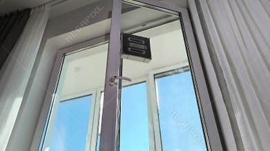 Robot cleaner washes window from low angle perspective showing underside
