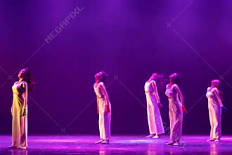 Graceful Contemporary Dancers Standing in Elegant Purple Illumination