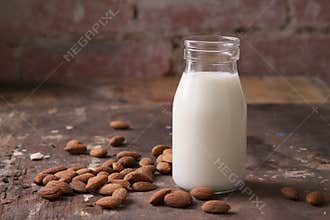 Almond milk in a glass jar with almonds