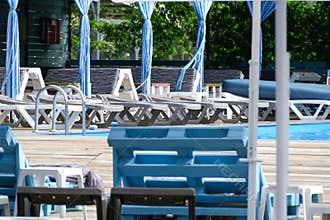 Outdoor Swimming Pool Recreation Area With Empty Sun Loungers
