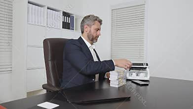 Businessman at office desk with money counting machine. Finance expert. Banker and currency. Office worker counting cash. Business
