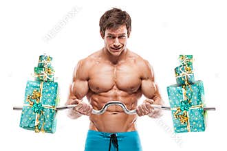 Muscular bodybuilder guy doing exercises with gifts over white b