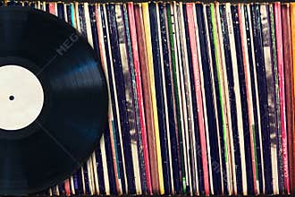 Vinyl record with copy space in front of a collection of albums (dummy titles)