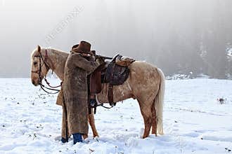 Cowboy shooting across his saddle