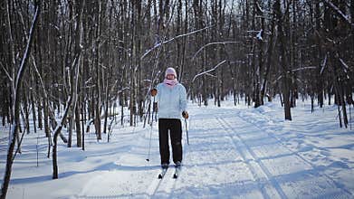 Woman Cross-Country Skiing Alone in Nature