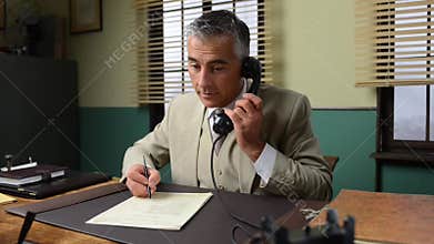 Smiling businessman working at office desk