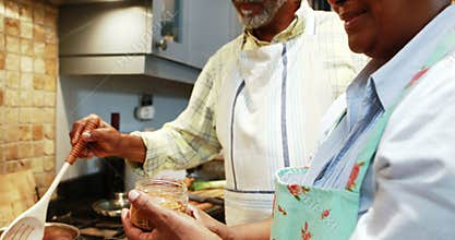 Senior couple preparing food in kitchen