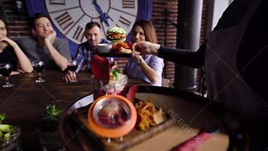 Waiter bringing food for guests