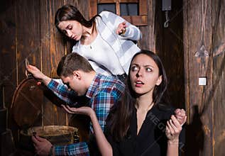 Company of young people trying to solve a conundrum to get out o