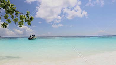 Idyllic tropical turquoise beach with white sand shore and boat at andaman sea Koh Tachai Island