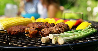 Grilling meat and vegetables on barbecue