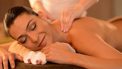 Young Woman Receiving Back Massage At Spa