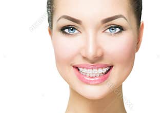 Woman smiling with ceramic braces on teeth