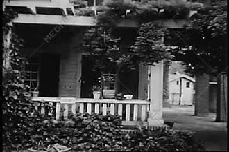 Tracking shot to entrance of house