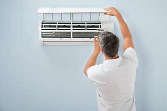 Man cleaning air conditioning system