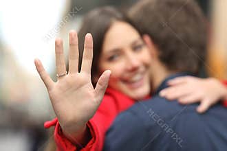 Happy woman showing engagement ring after proposal