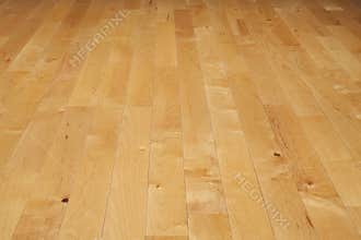 Hardwood basketball court floor viewed from a low angle