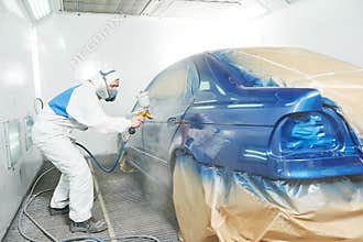 Worker painting auto car body