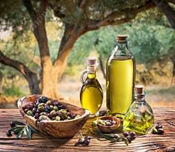 Olives and olive oil in a bottle.