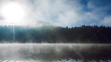 Beautiful sunrise over the mountain and fog over the mystic ake, video