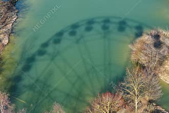 Ferris wheel shadow image cast on water