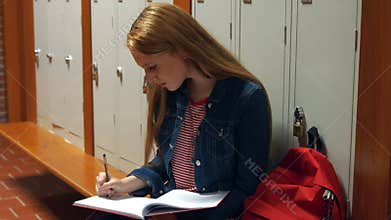 Student writing into her school journal